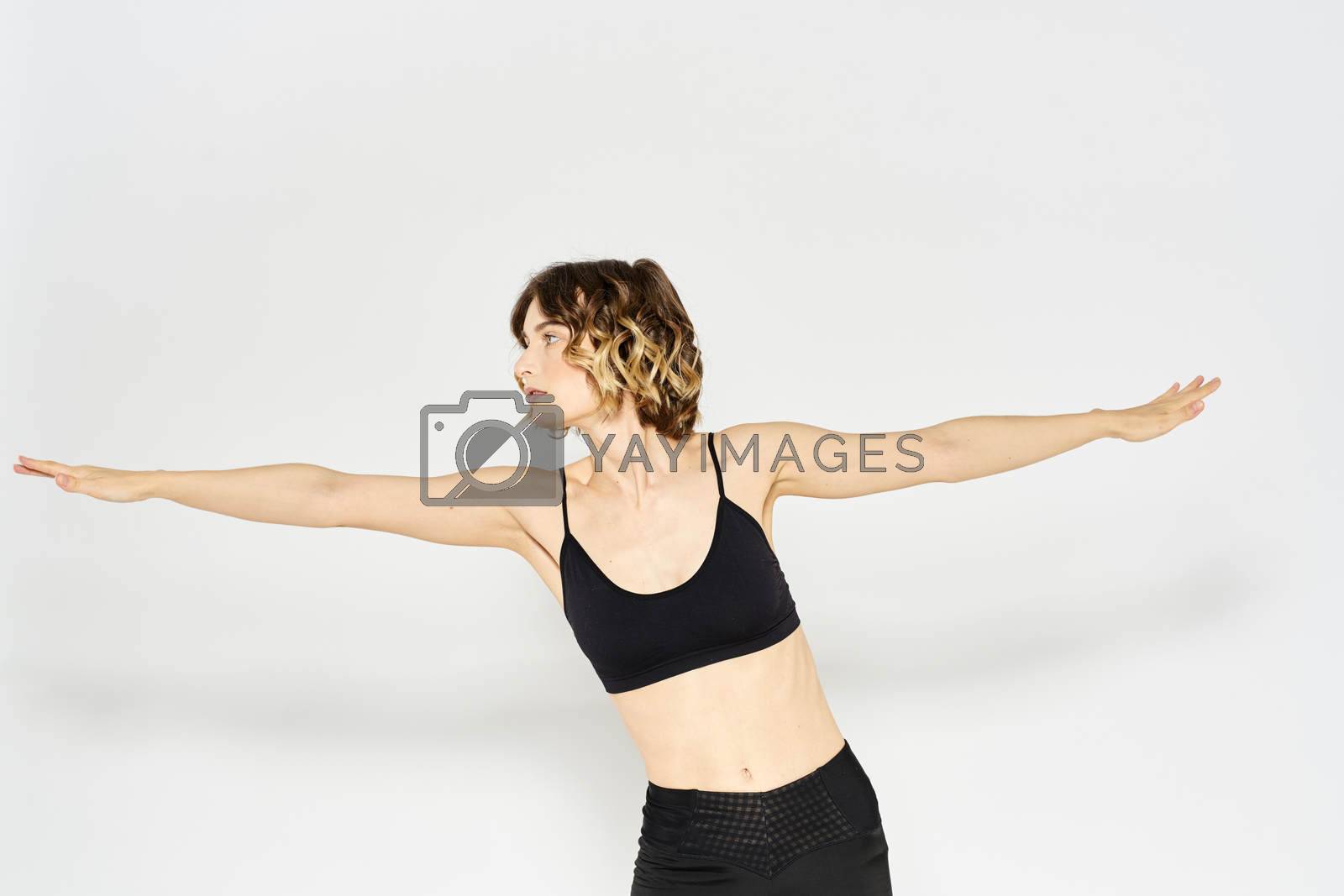 Woman in sportswear on a light background exercise fitness sport balance model. High quality photo