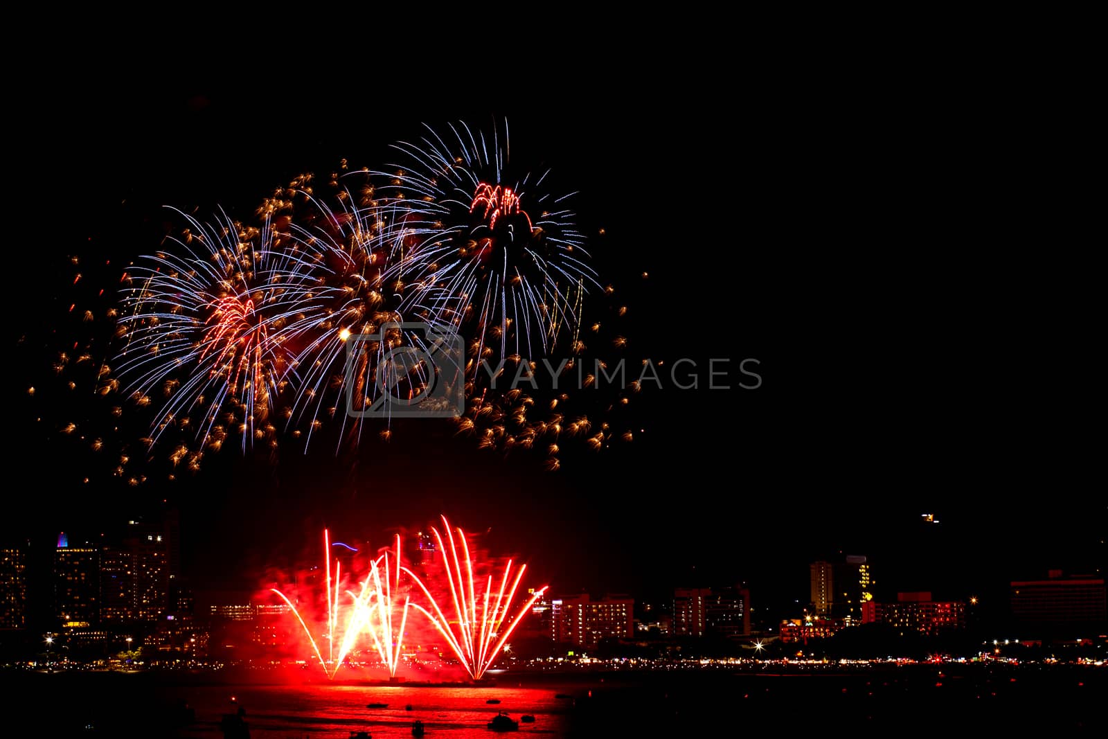 Royalty free image of Many flashing fireworks with night cityscape background celebrat by nnudoo