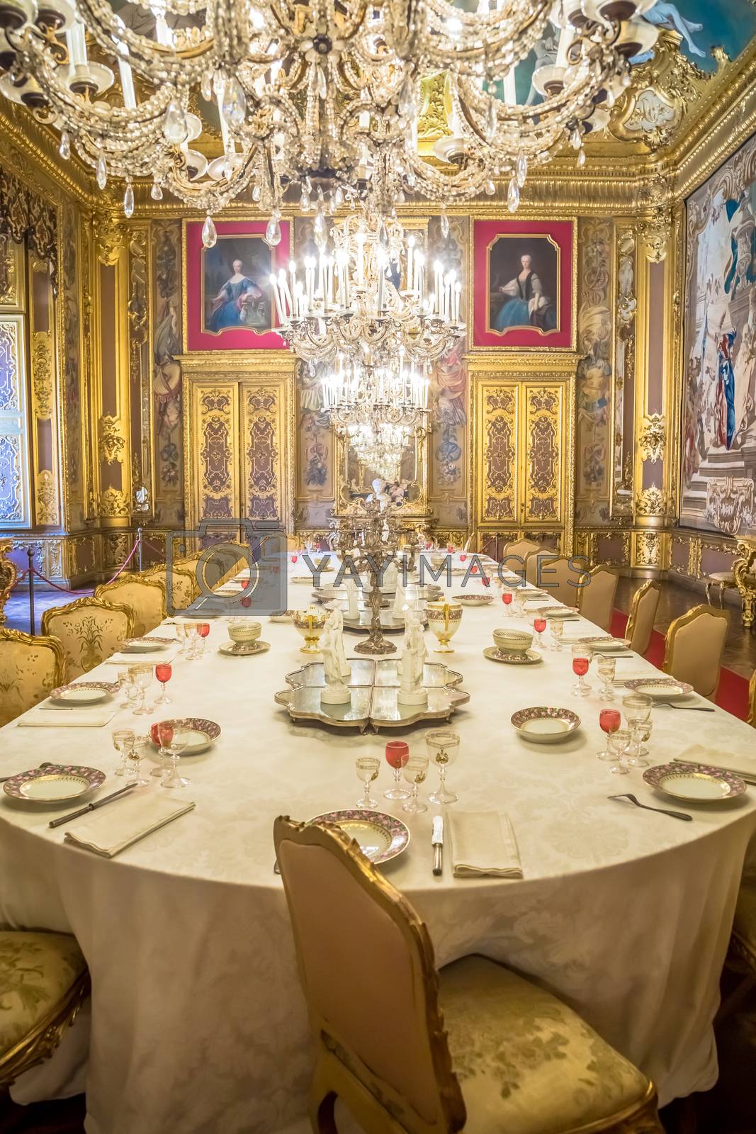 Royalty free image of Luxury Baroque dining room with gala dinner table setting by Perseomedusa