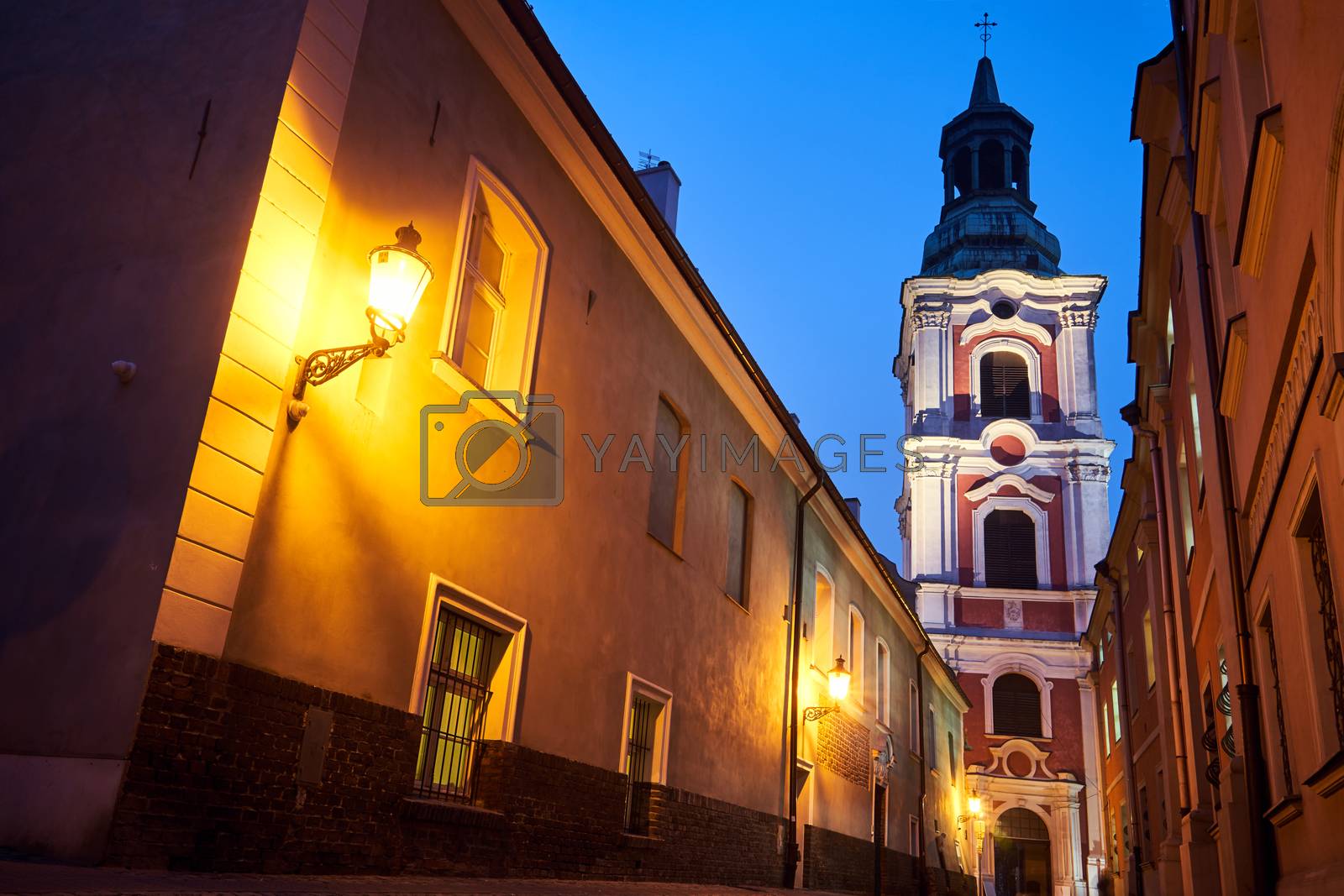 Royalty free image of narrow street and belfry of the baroque historic church by gkordus