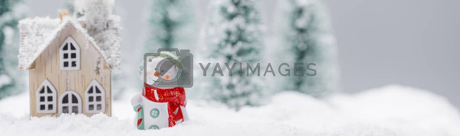 Royalty free image of Snowman and house in winter by Yellowj