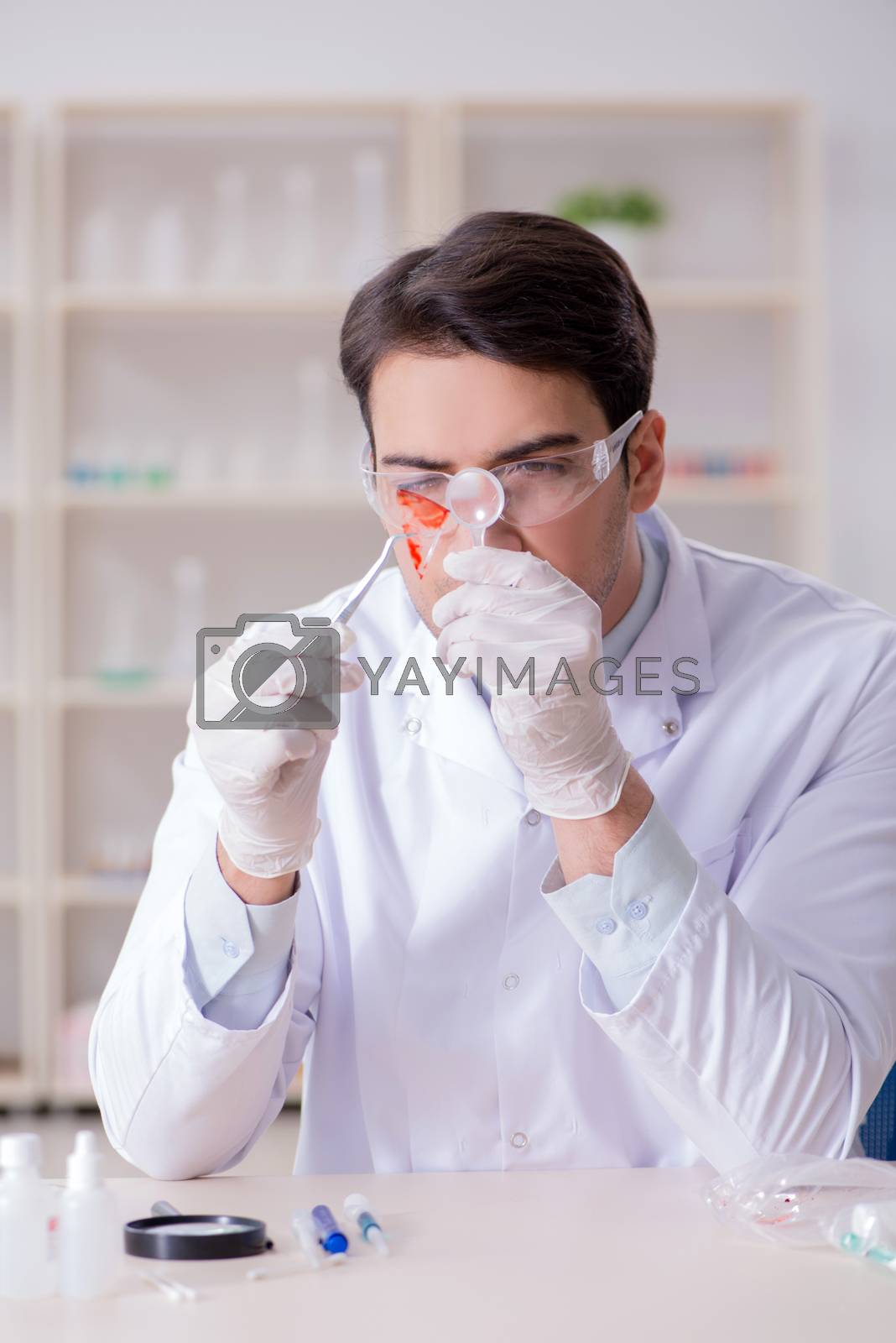 Royalty free image of Expert criminologist working in the lab for evidence by Elnur