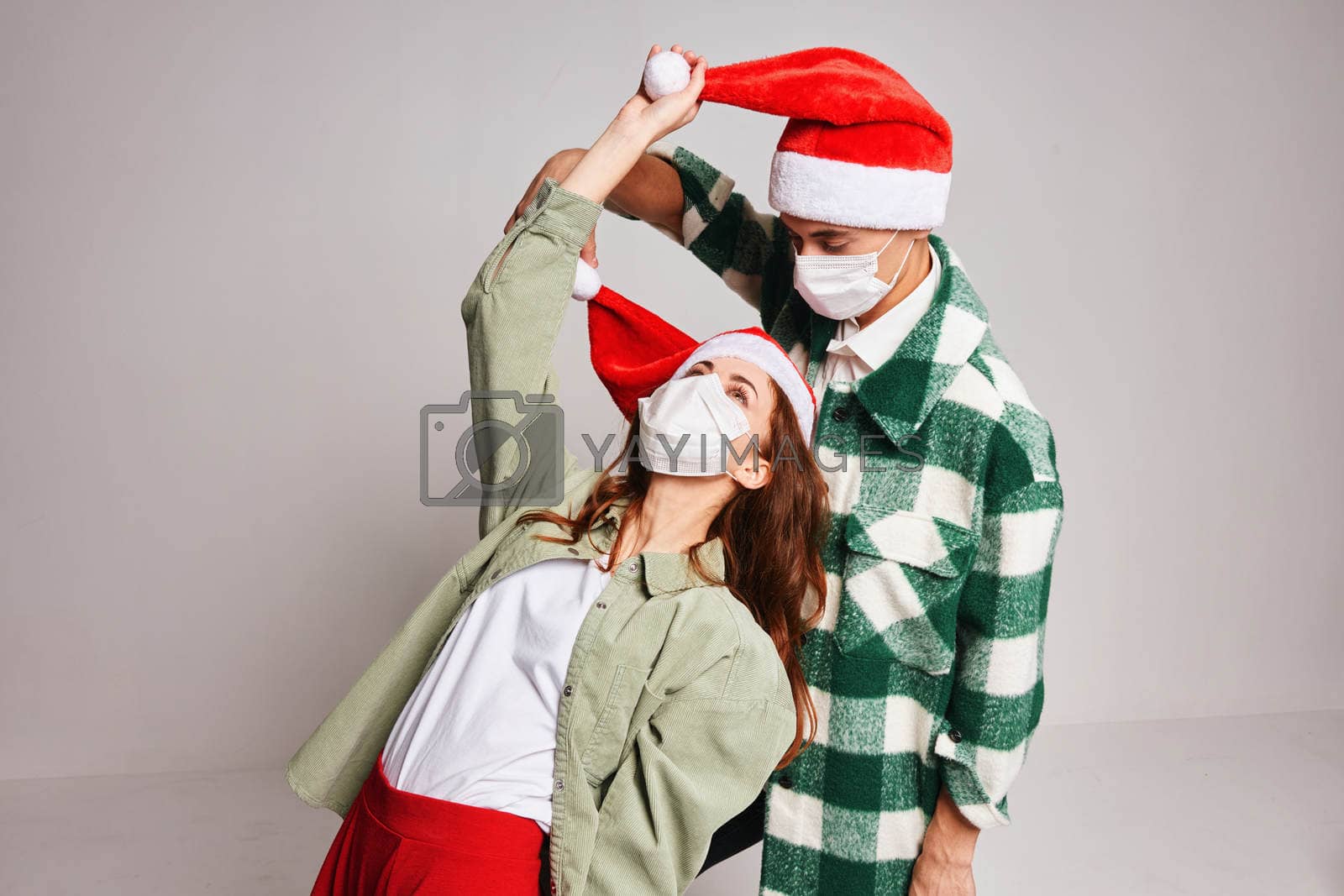 Cute young couple new year clothes holiday lifestyle medical masks. High quality photo