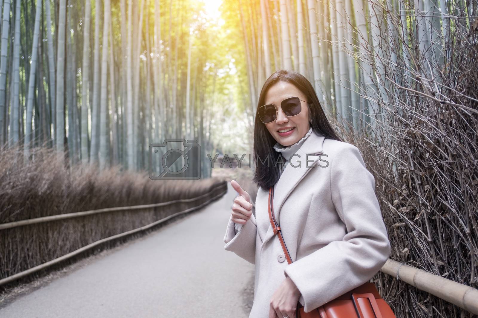 Royalty free image of  Asian woman traveling at Bamboo Forest in Kyoto, Japan.  by Surasak