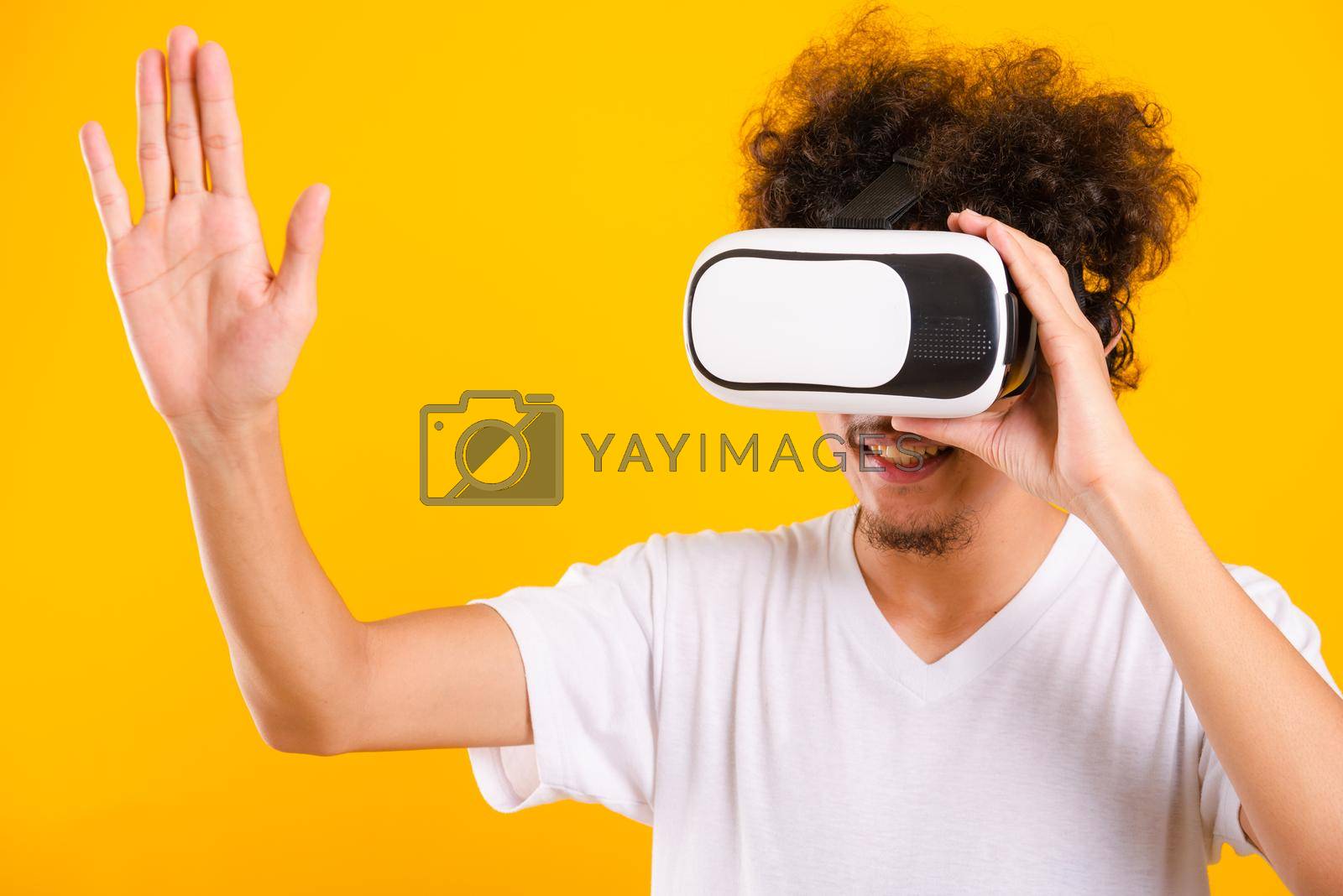 Royalty free image of Asian handsome man with curly hair he using virtual reality headset or VR glass by Sorapop