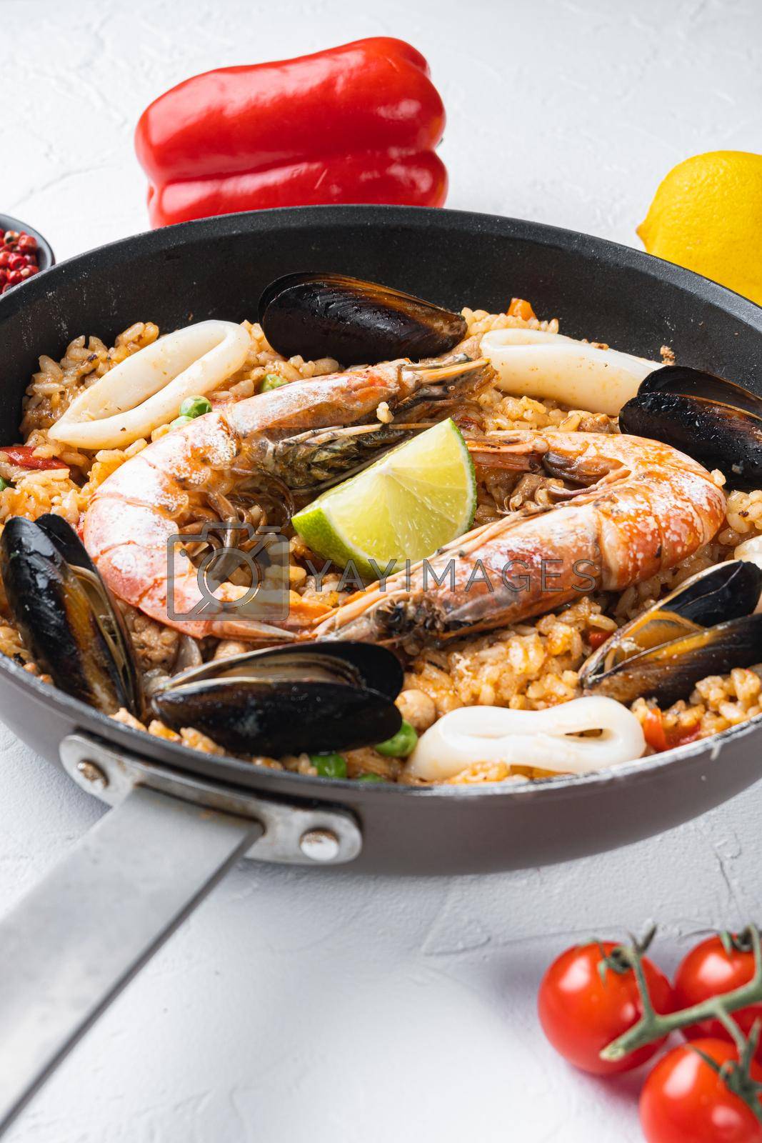 Royalty free image of Paella with seafood and chicken on white background by Ilianesolenyi