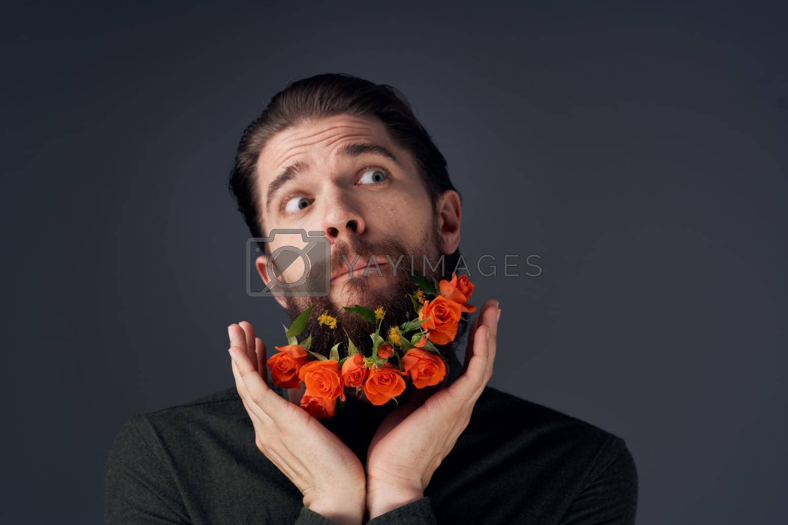 portrait of a man flowers in a beard decoration romance black background. High quality photo