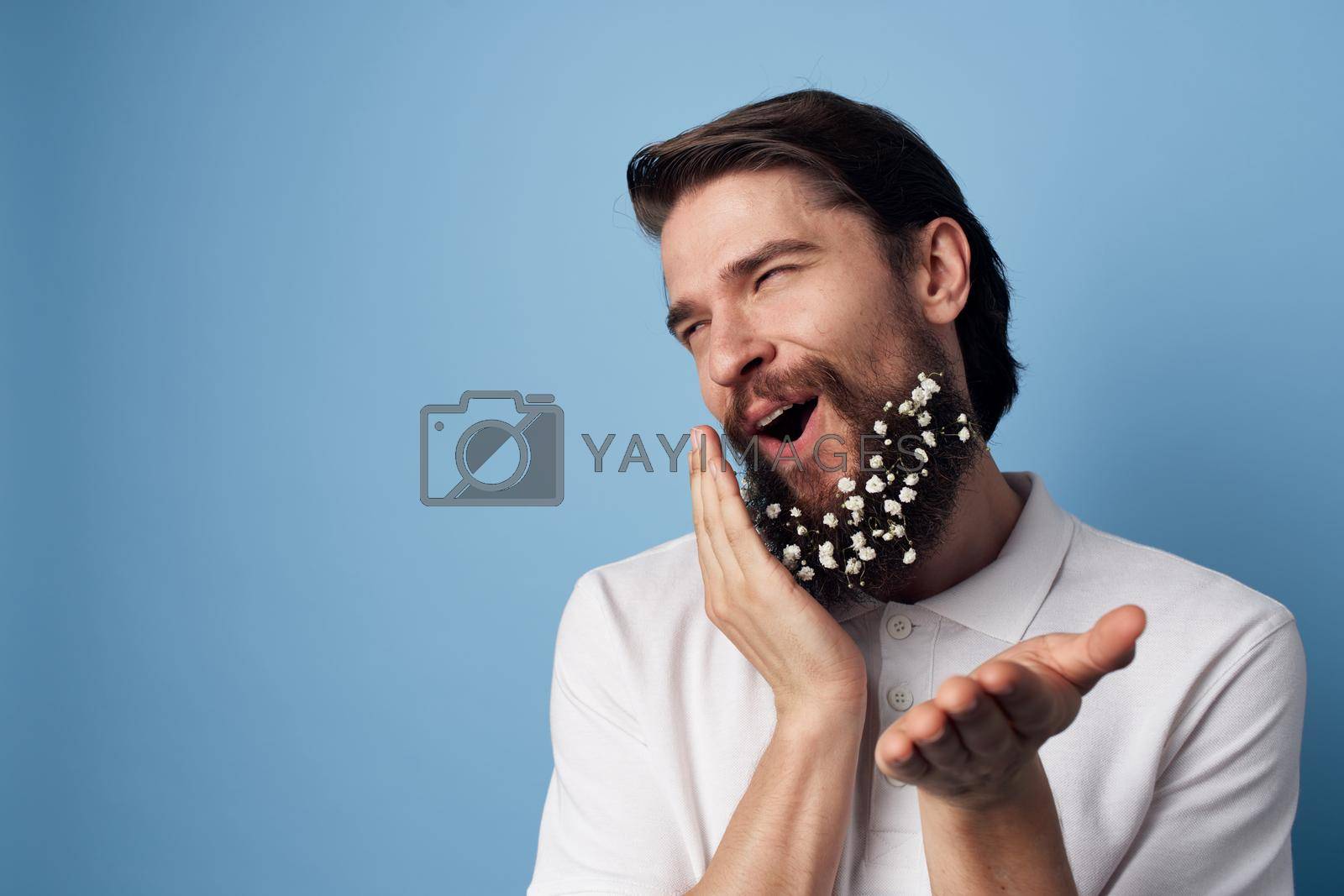 Royalty free image of Cheerful bearded man in sanitary emotions white shirt blue background by SHOTPRIME