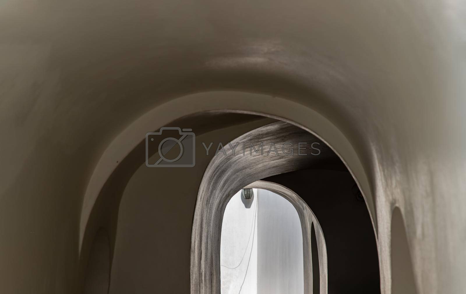 Royalty free image of Corridor Under the Ancient building with cement wall on both sides leading into exit.  by tosirikul