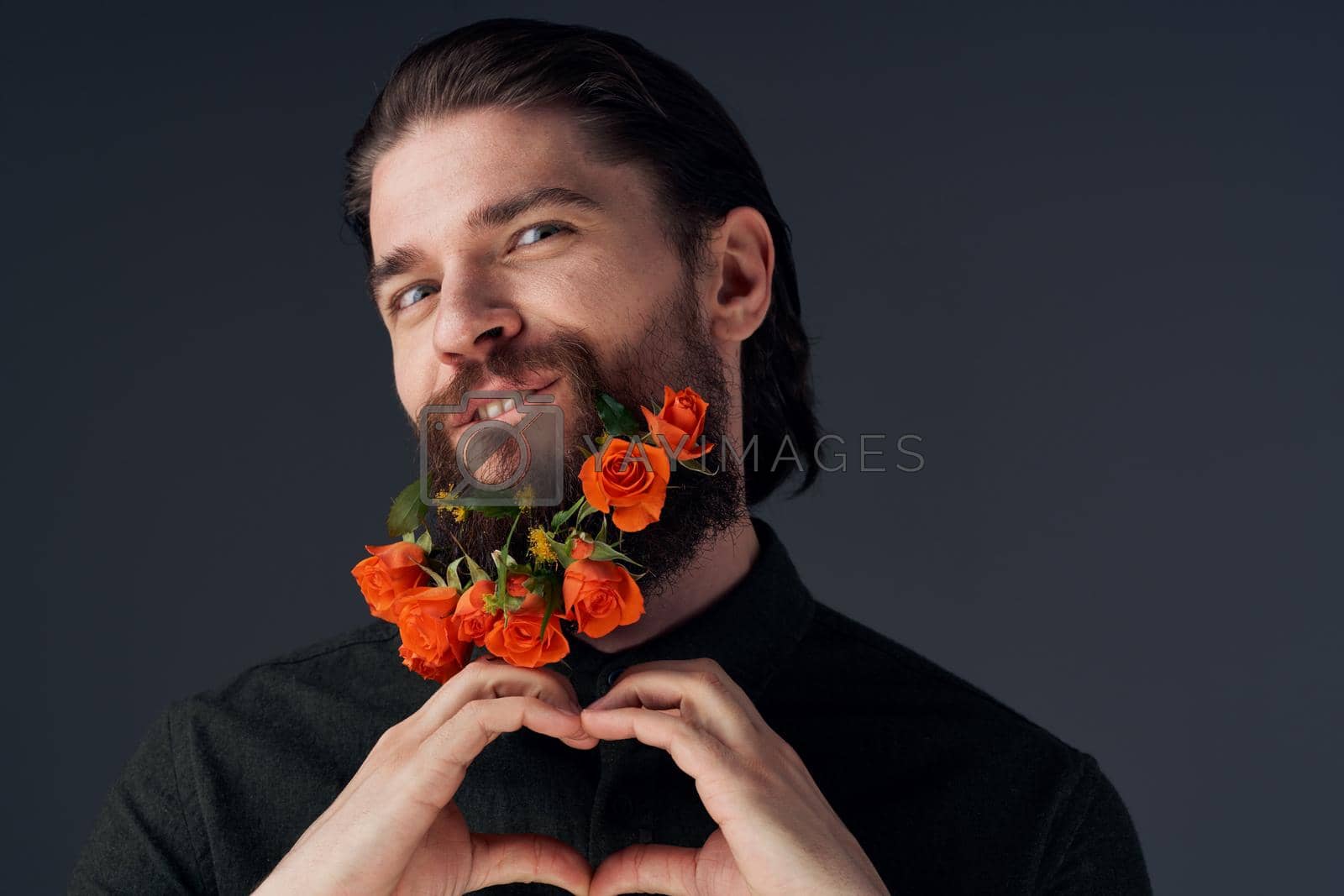 Portrait of a bearded man flowers decoration romance close-up black background. High quality photo