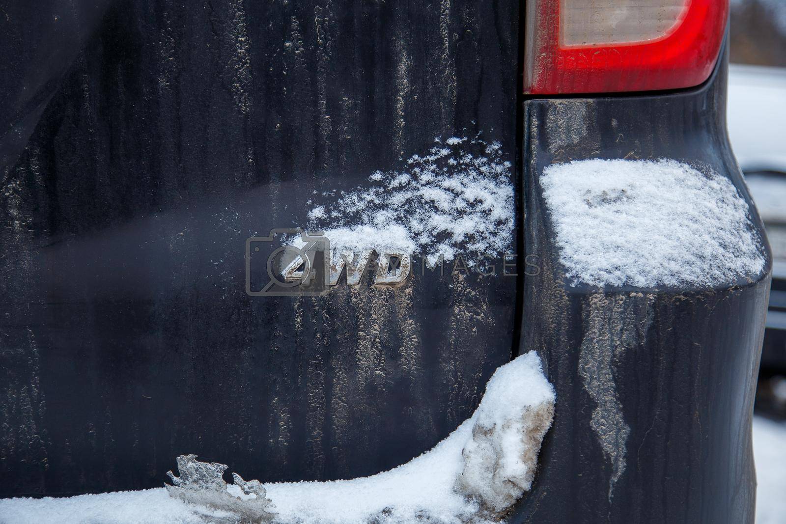 Royalty free image of an abbreviation 4wd - Four-wheel drive - on dirty black car back by z1b