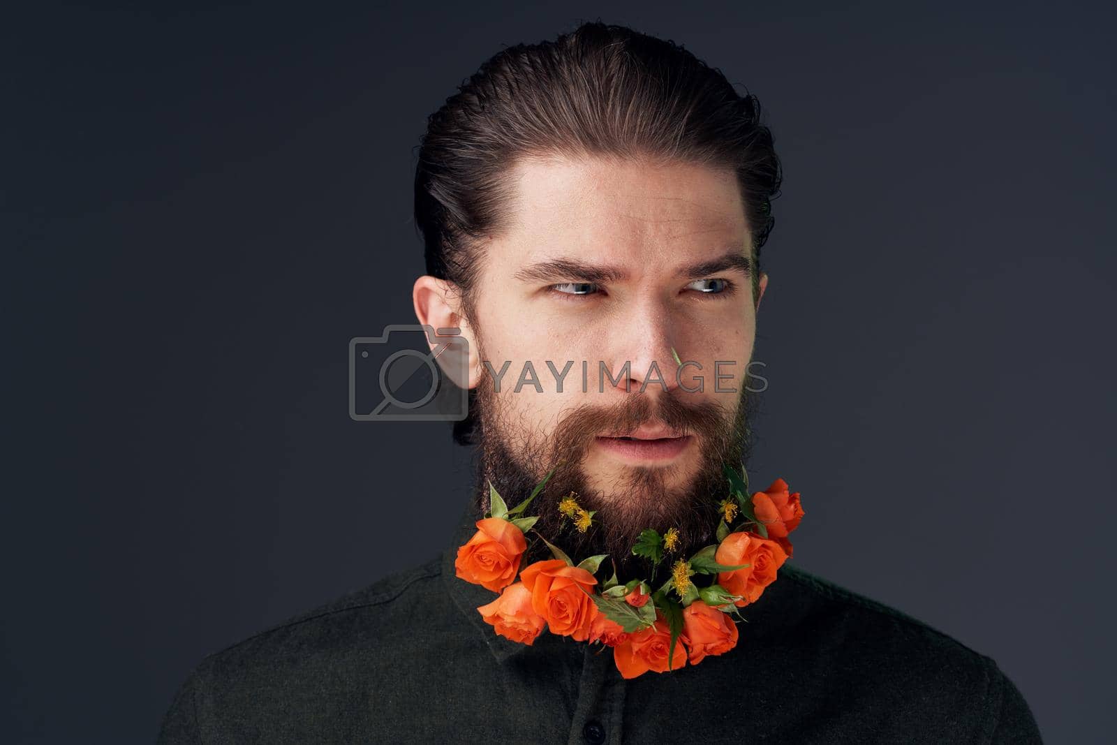 bearded man flowers decoration close-up romance black background. High quality photo