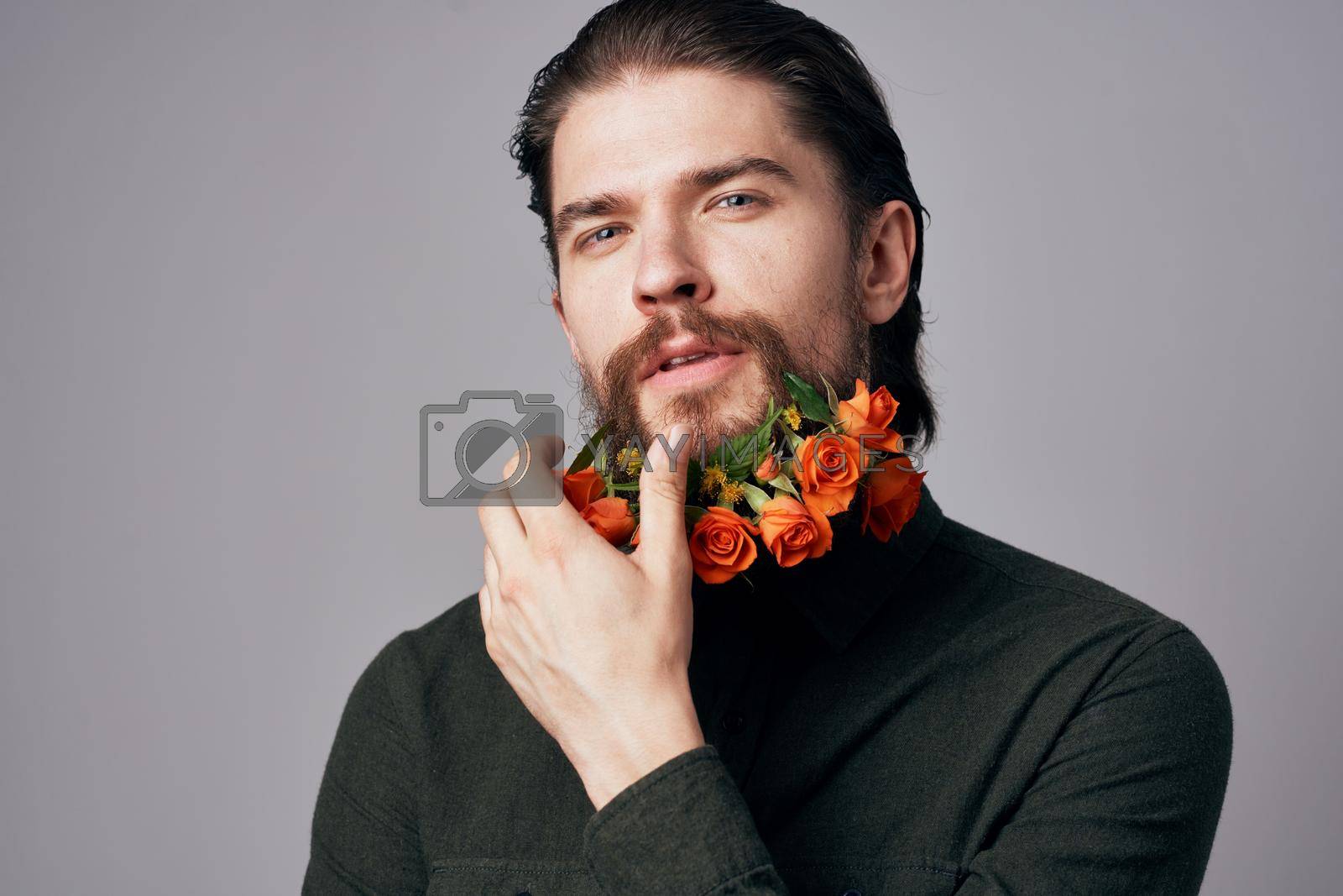 handsome man flowers in a beard black jacket elegant style romance. High quality photo