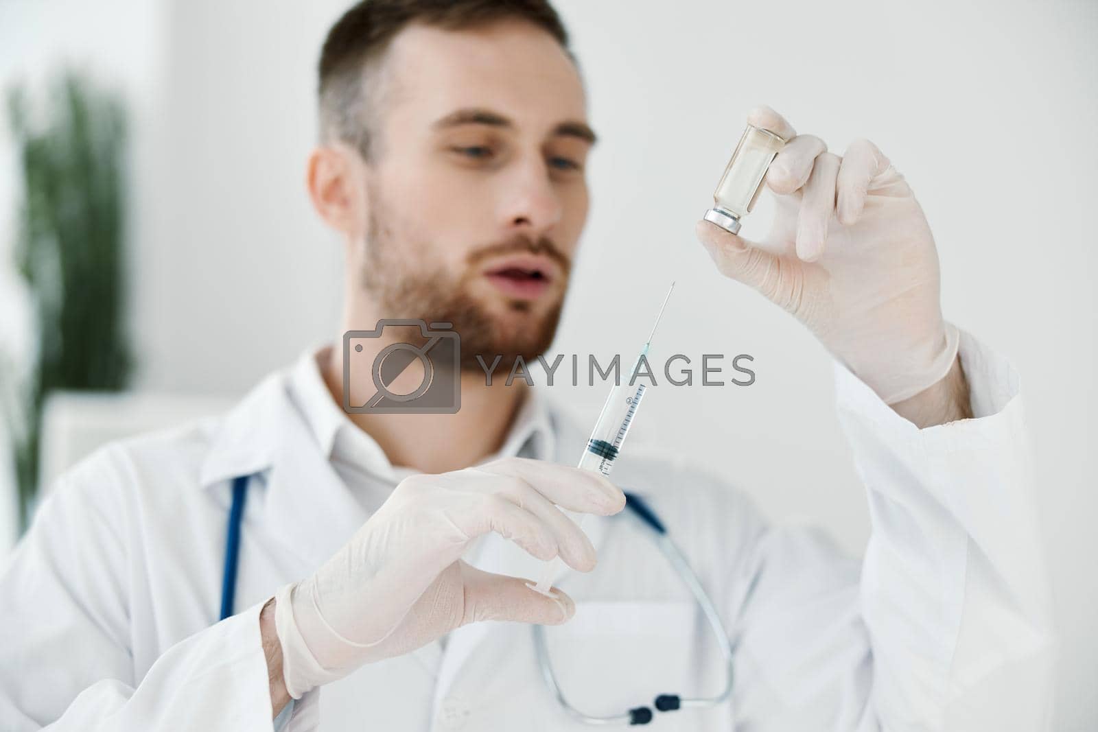 Royalty free image of doctor syringe medical gloves and ampoule with vaccine laboratory room covid vaccination by SHOTPRIME