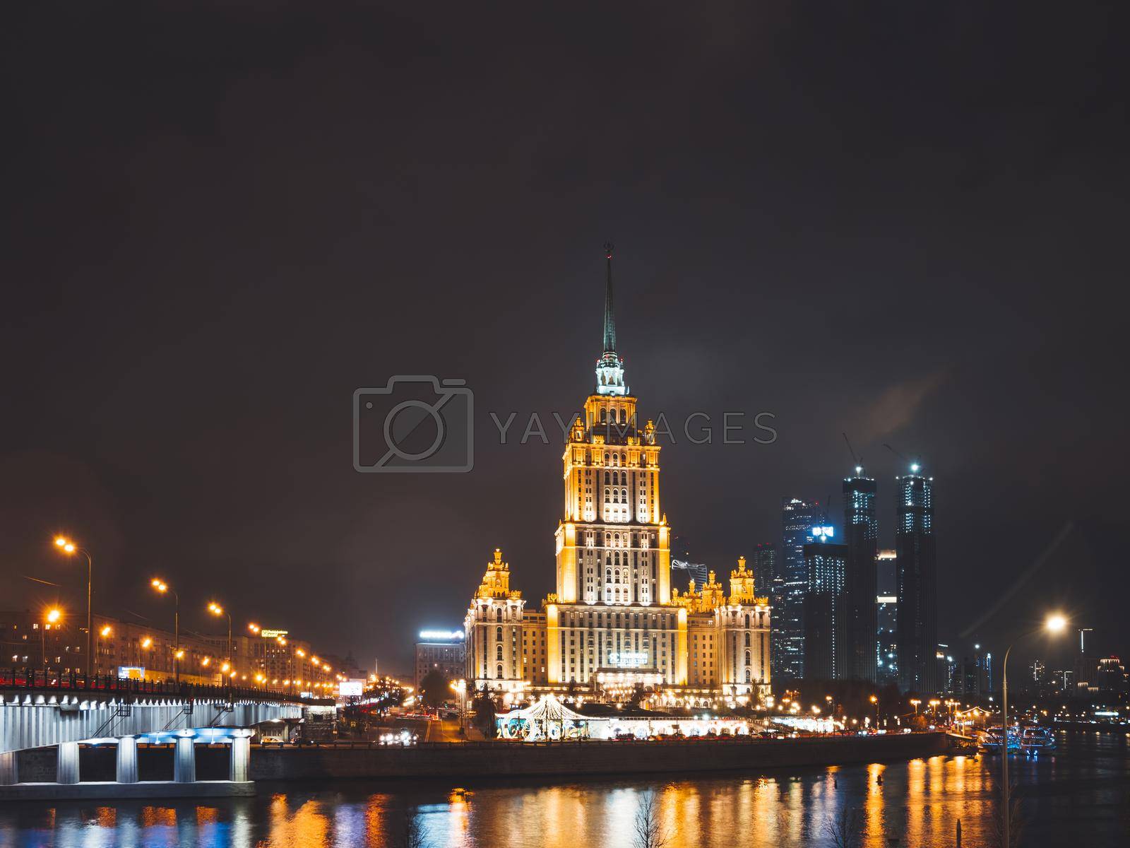 Royalty free image of MOSCOW, RUSSIA - November 14, 2020. Night view on Hotel Ukraine, Radisson Collection and Moscow-river embanment. by aksenovko