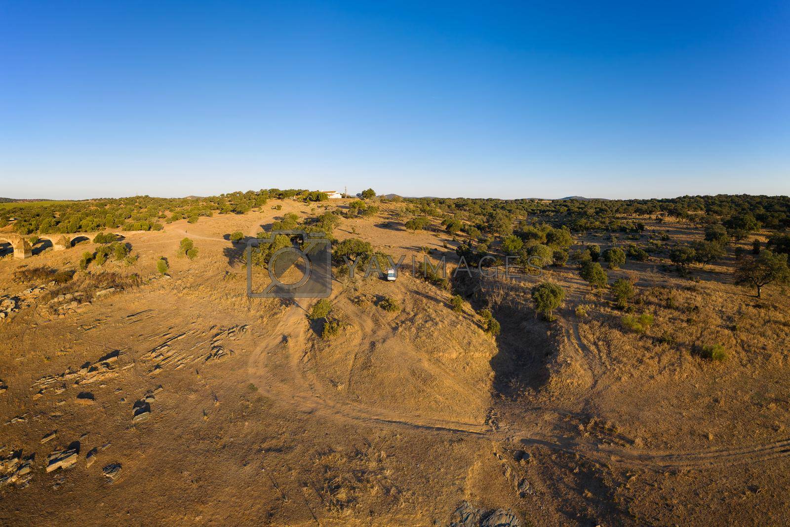 Royalty free image of Camper van drone aerial view alone on an Alentejo landscape between the trees, in Portugal by Luispinaphotography