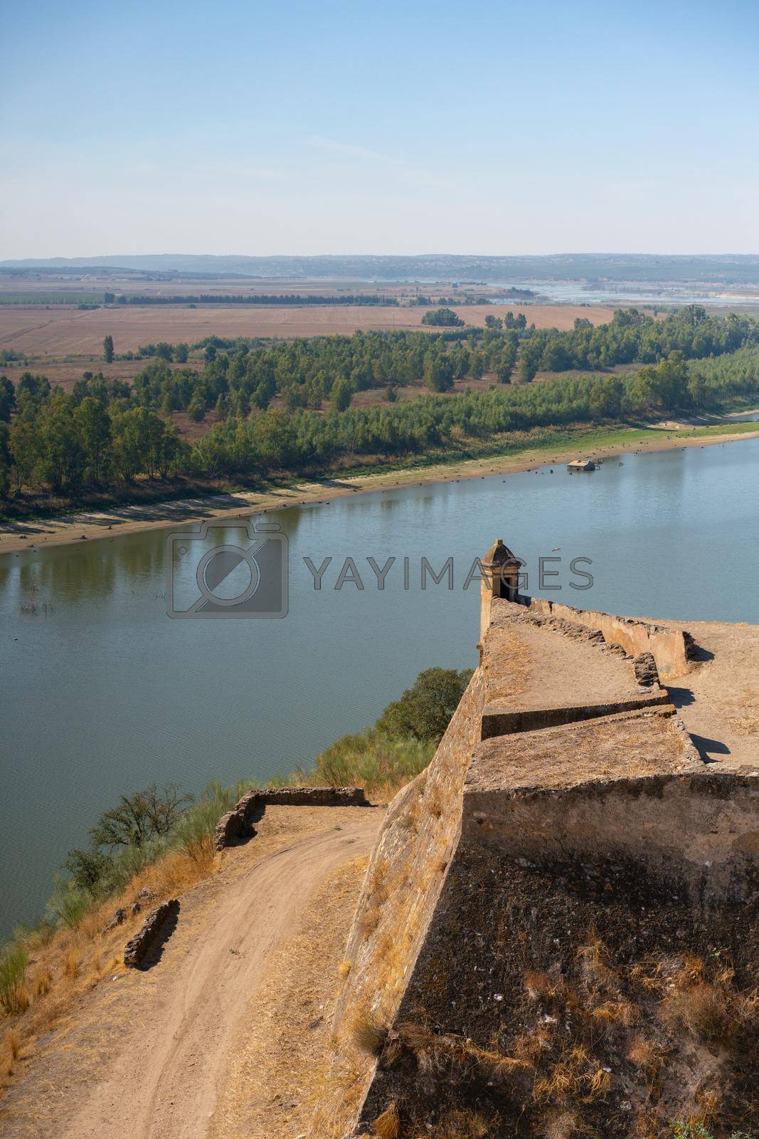 Royalty free image of Juromenha beautiful ruin castle tower fortress and guadiana river in Alentejo, Portugal by Luispinaphotography