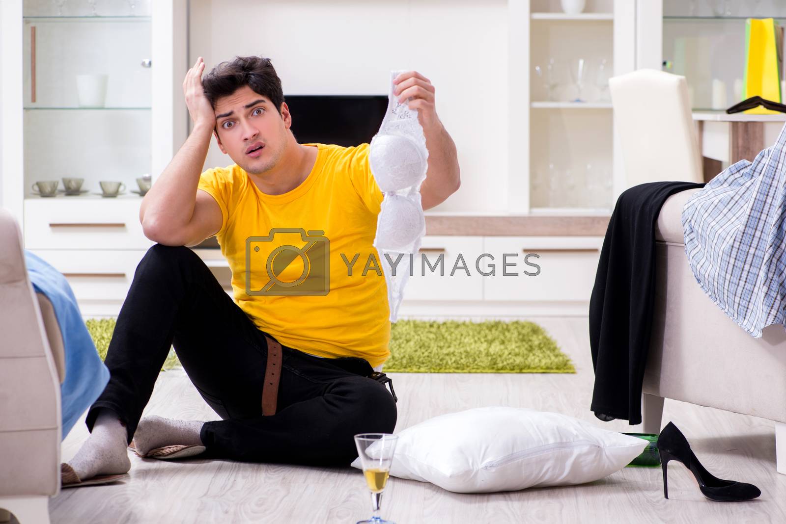 Royalty free image of Man with mess at home after house party by Elnur