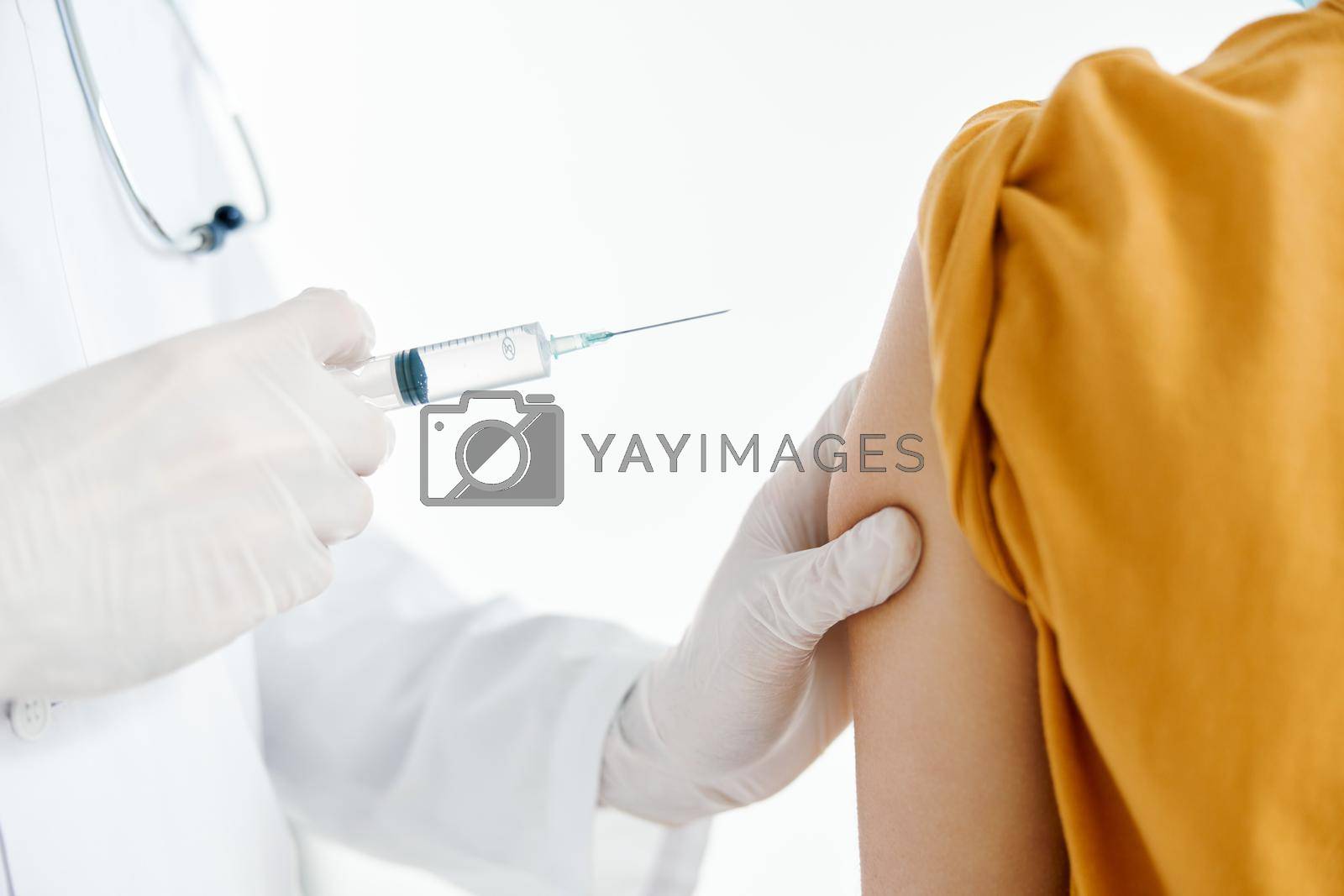 Royalty free image of doctor giving injection to patient's shoulder close-up cropped view syringe epidemic covid by SHOTPRIME