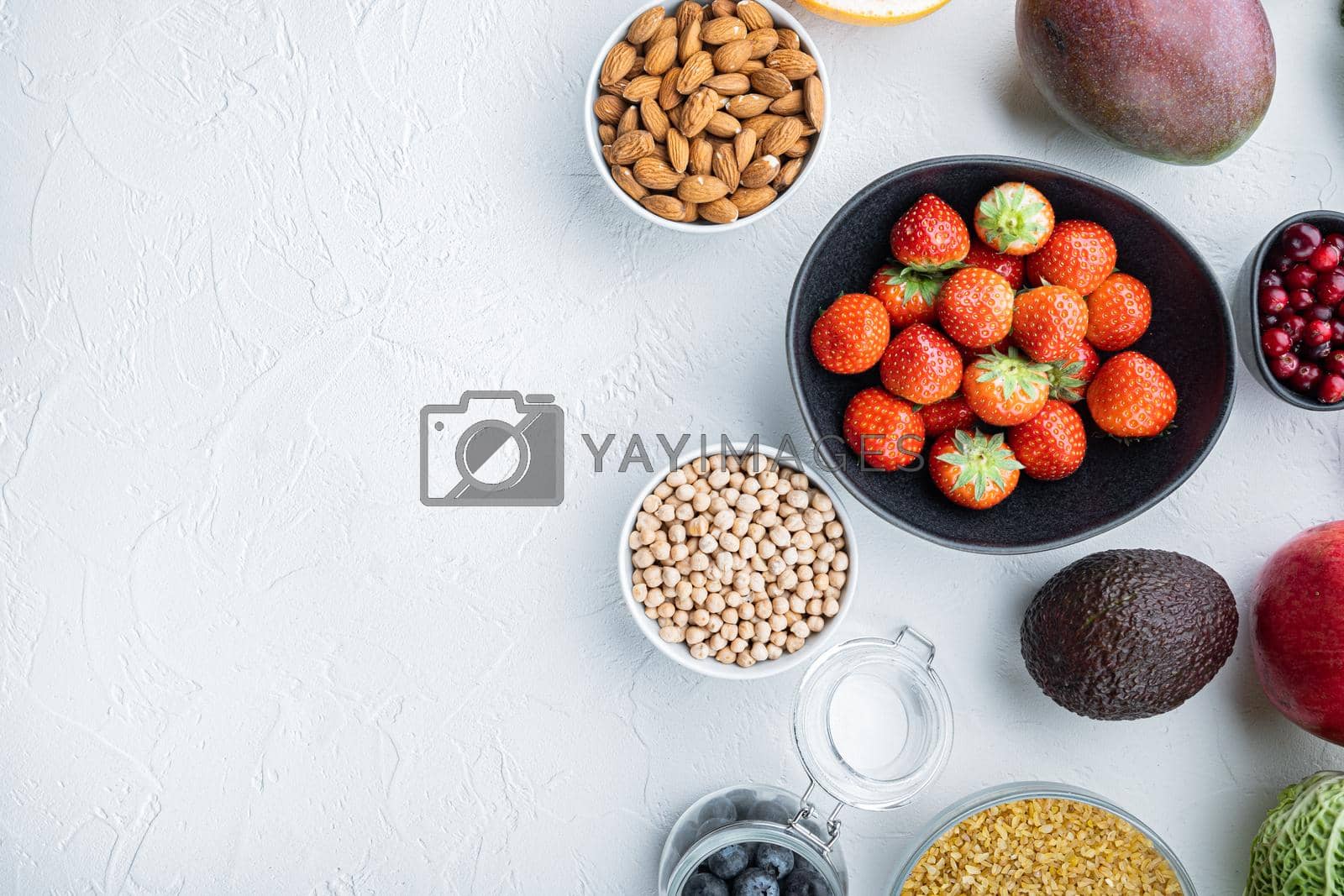 Royalty free image of Balanced diet organic healthy food clean eating selection, flat lay with space for text, on white background by Ilianesolenyi