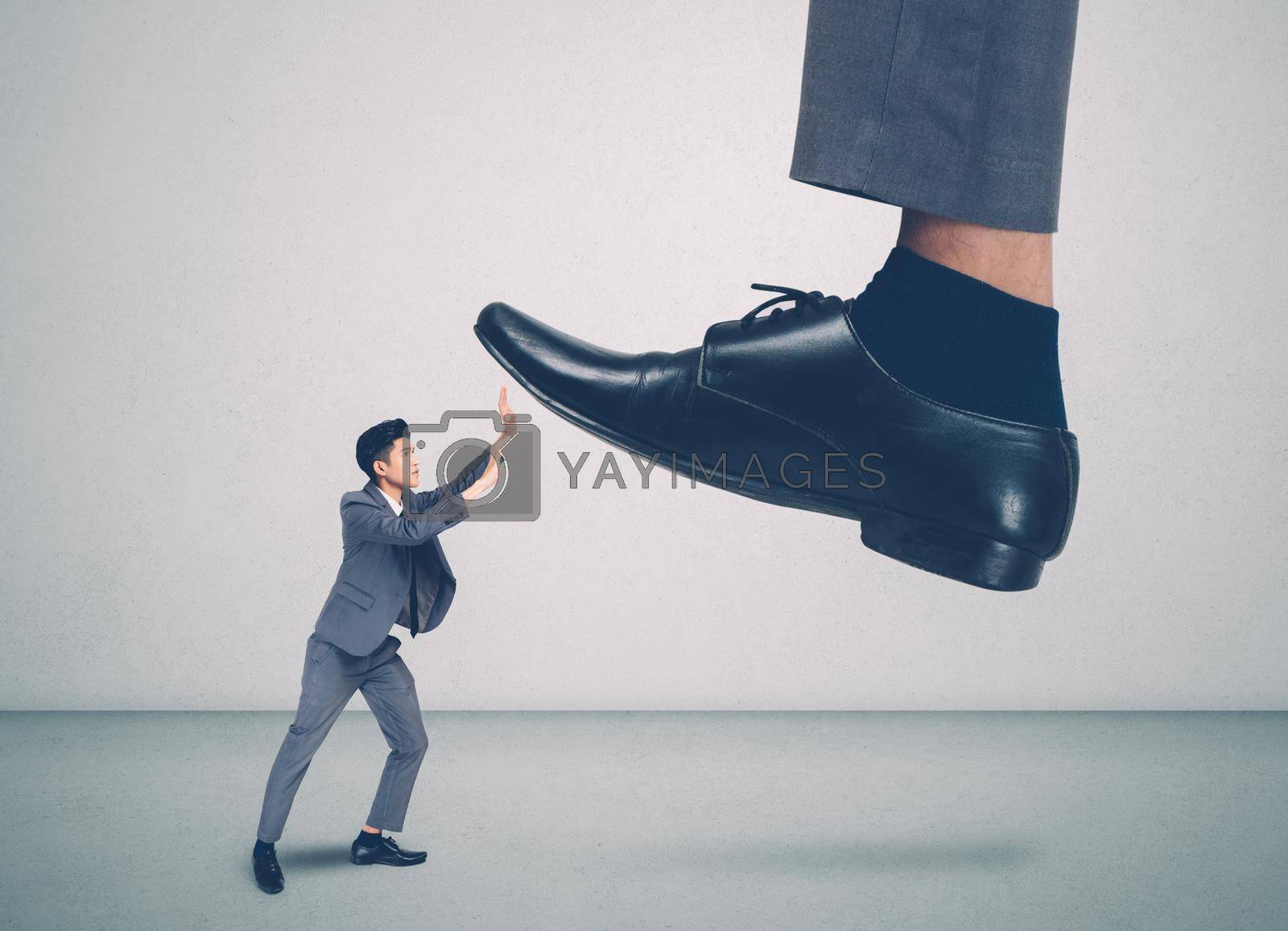 Royalty free image of foot of leader or boss with authority huge trample on frightened employee with bullying, businessman in suite strong and defense, exploitation and dominance, scared and fight, business concept. by nnudoo