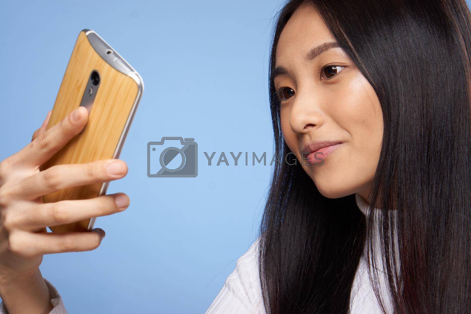pretty asian woman looking at phone technology communication lifestyle. High quality photo