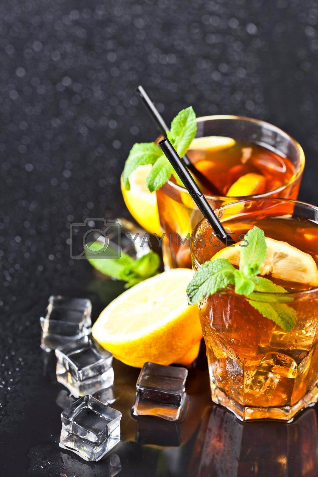 Royalty free image of Two glasses with cold traditional iced tea with lemon, mint leaves and ice cubes by marylooo