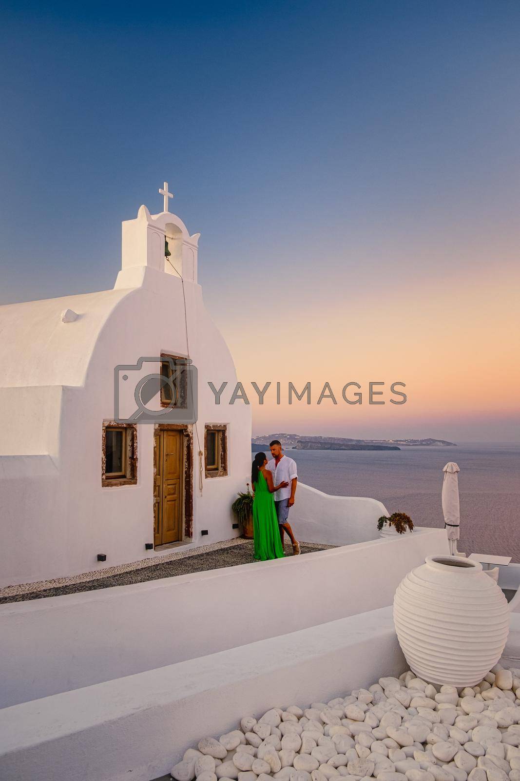 Royalty free image of Santorini Greece, young couple mid age European and Asian on vacation at the Greek village of Oia Santorini Greece, luxury vacation Santorini by fokkebok