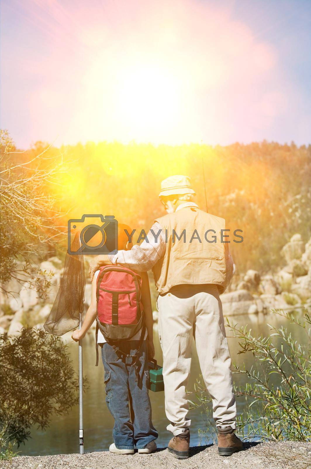 Royalty free image of Grandfather and Grandson Fishing at Lake by moodboard