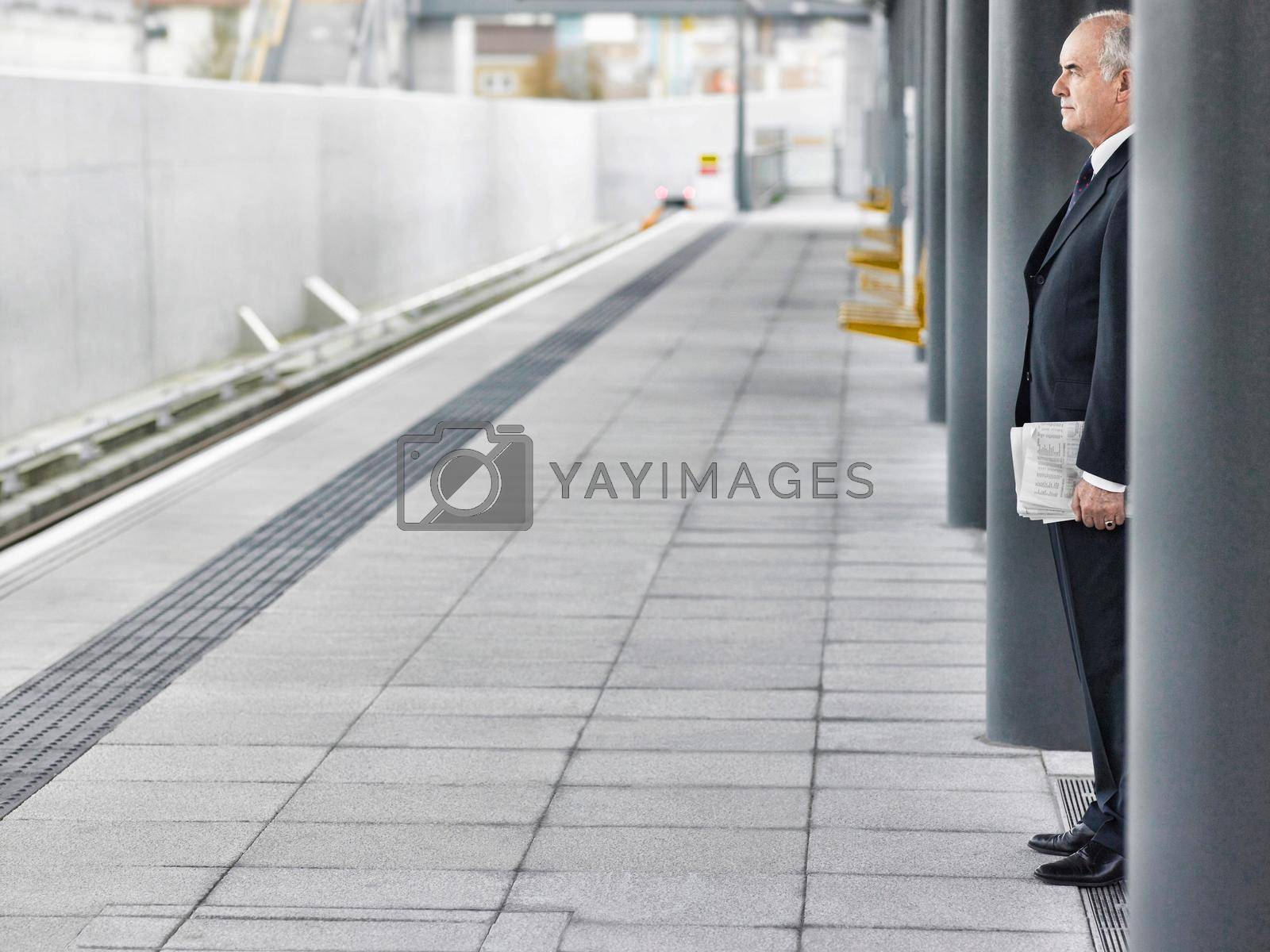 Mature businessman waiting at train station
