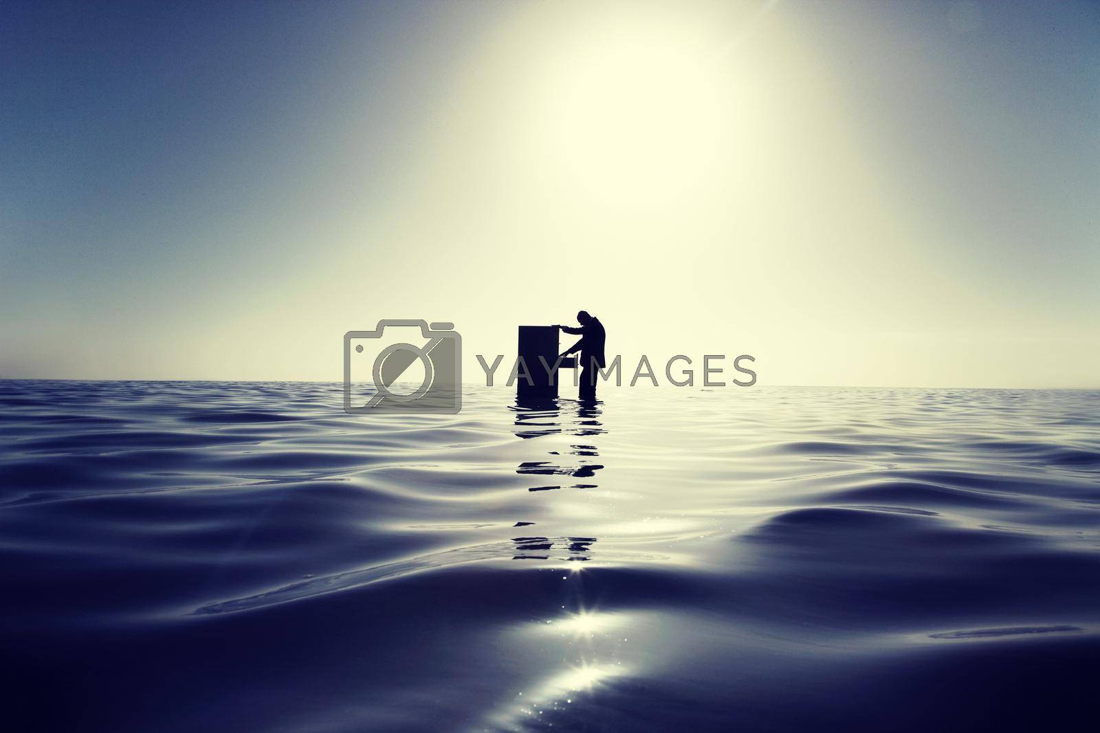 Royalty free image of Businessman Standing in the Ocean Searching Through a Filing Cabinet by moodboard