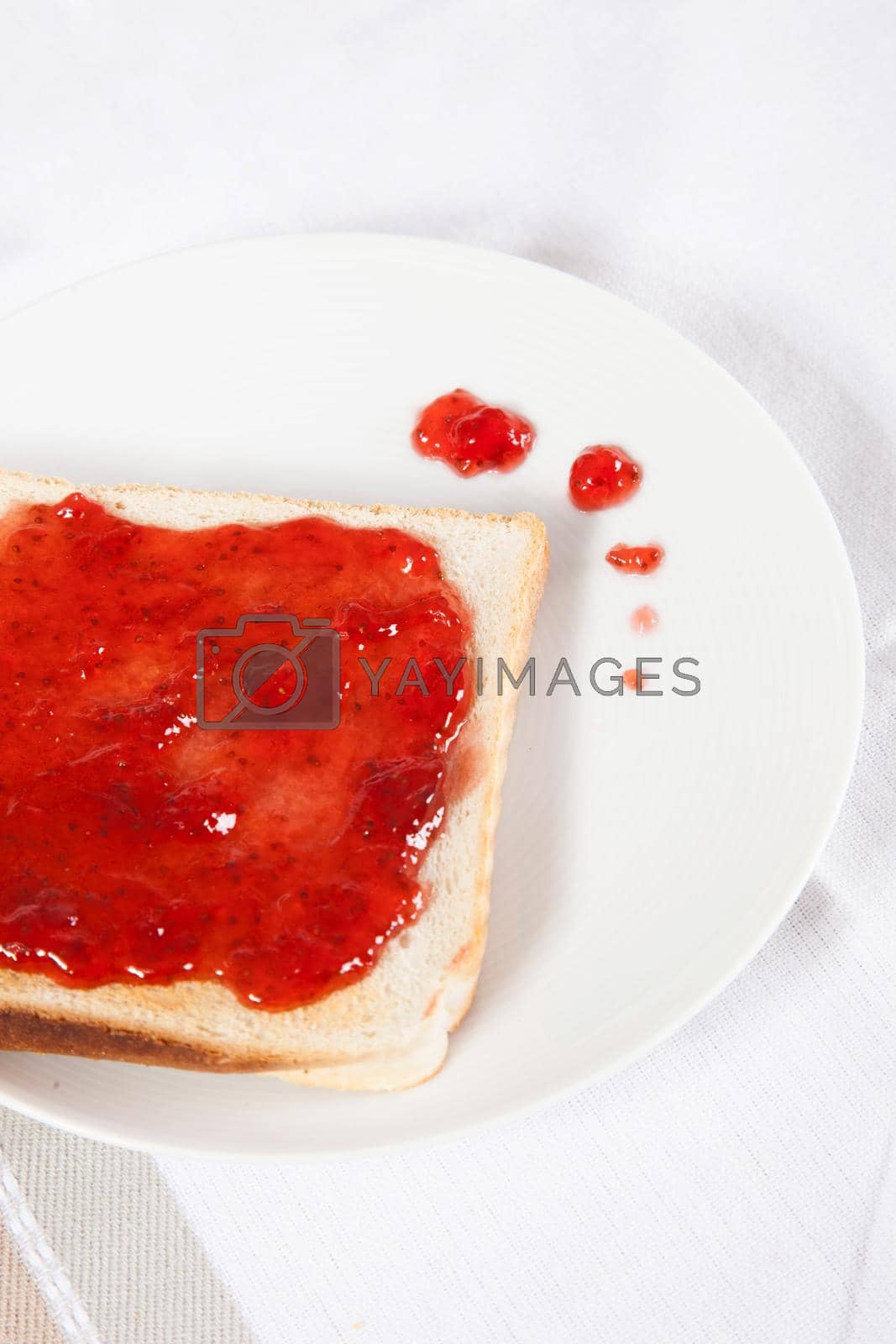 Royalty free image of Spilled strawberry jam jelly on toast by moodboard