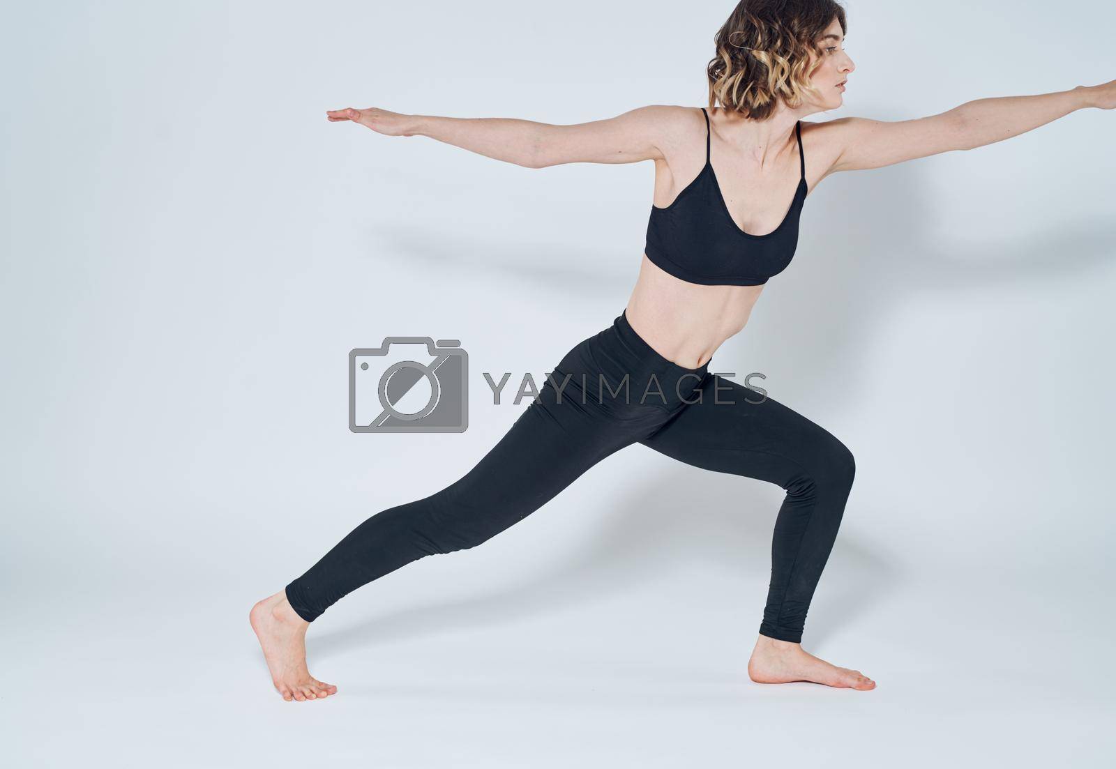 sportive woman doing exercises bending knees yoga asana. High quality photo