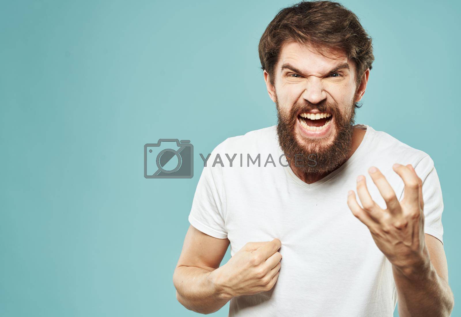 Royalty free image of Aggressive man emotions and stress irritability blue background by SHOTPRIME