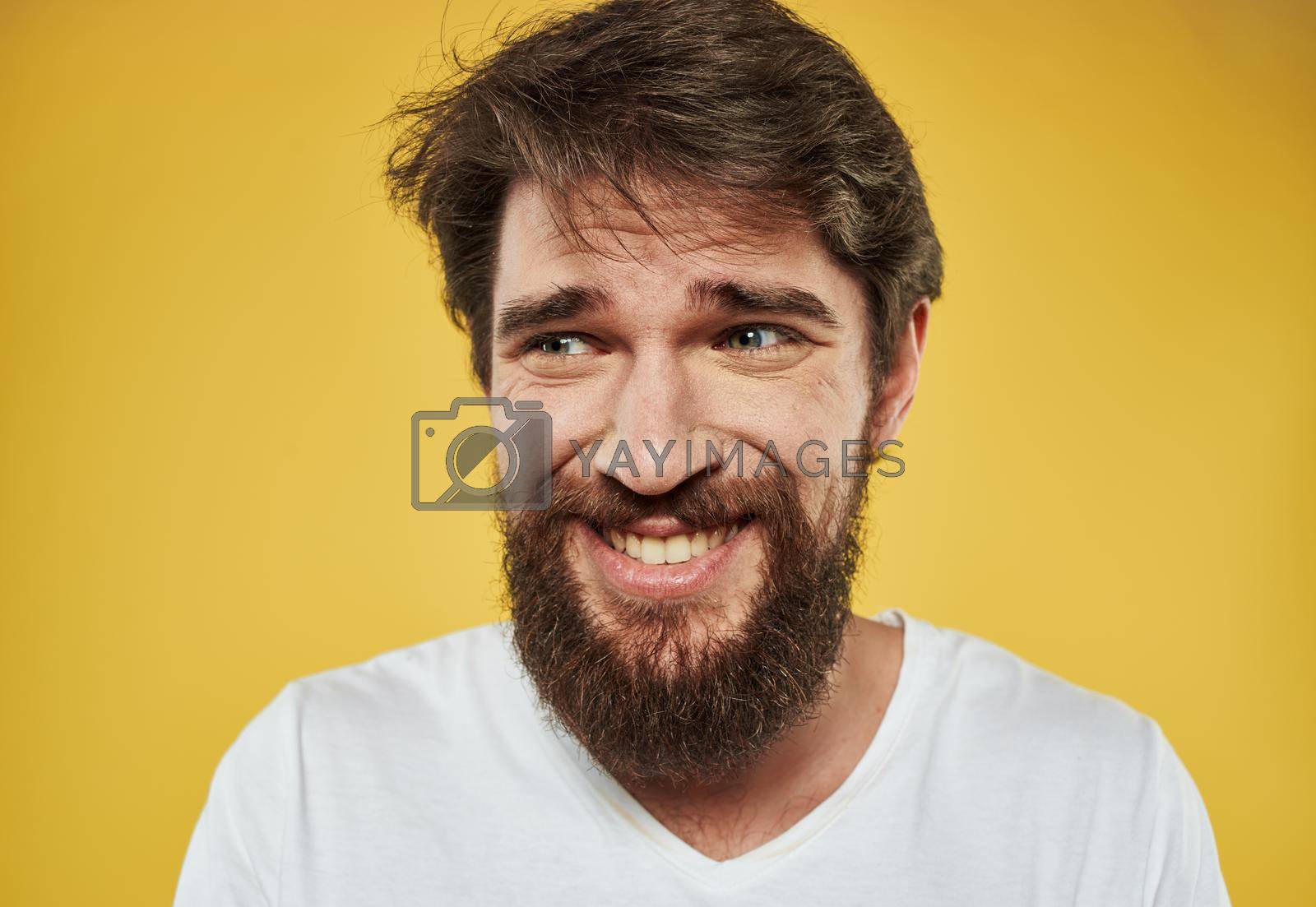Royalty free image of Emotional man with thick beard grinning model yellow background by SHOTPRIME