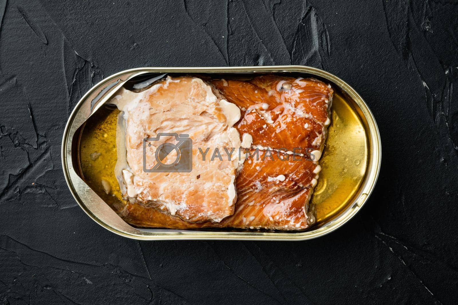Royalty free image of Canned Smoked Trout Fillets, in tin can, on black background, top view flat lay by Ilianesolenyi