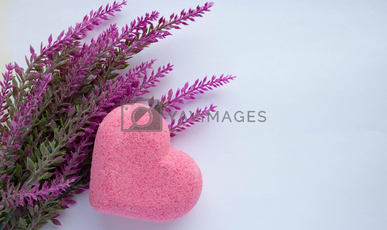 Royalty free image of Purple heart bath salt and a branch of artificial lavender on a white background. Space for text by lapushka62