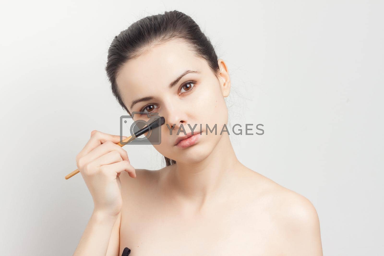 Royalty free image of attractive brunette naked shoulders cosmetics skin care makeup by SHOTPRIME