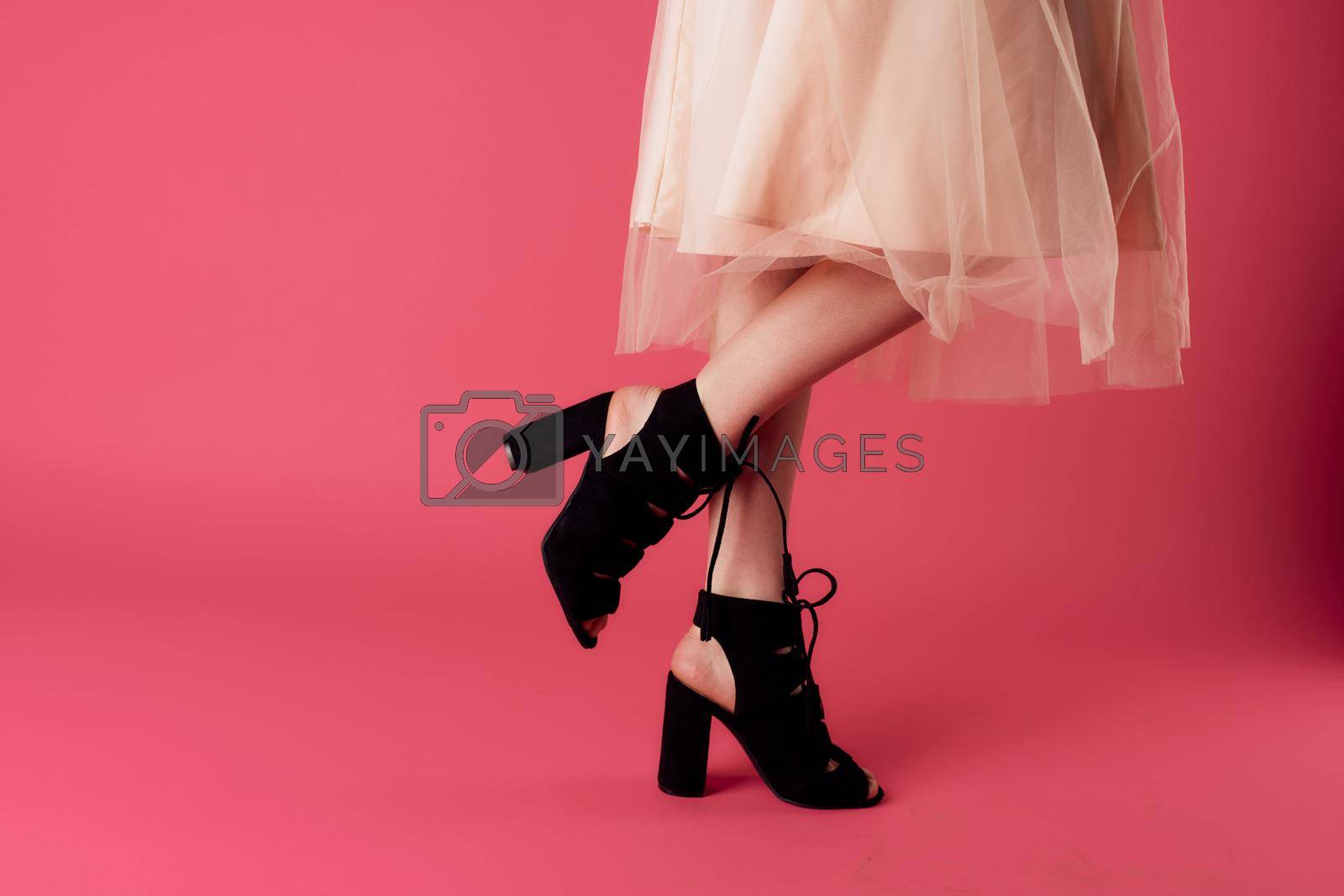Royalty free image of Womens feet fashionable shoes charm pink background shopping by SHOTPRIME