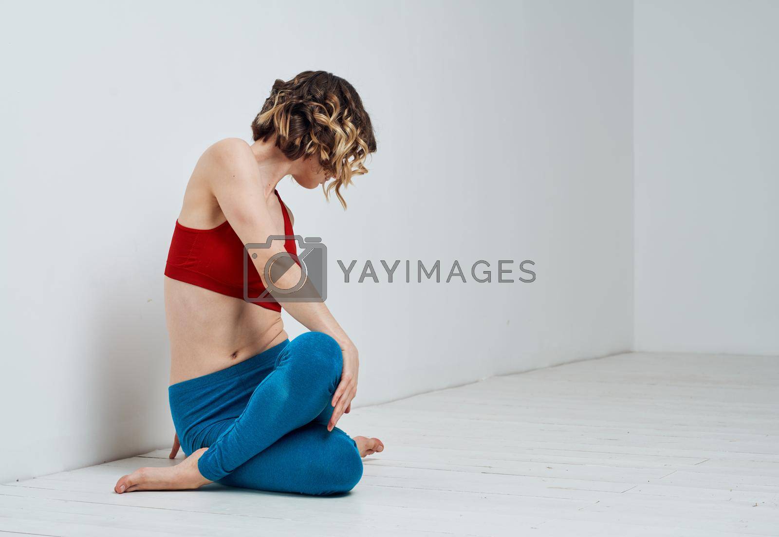 Blue leggings red t-shirt woman yoga asana twisting. High quality photo