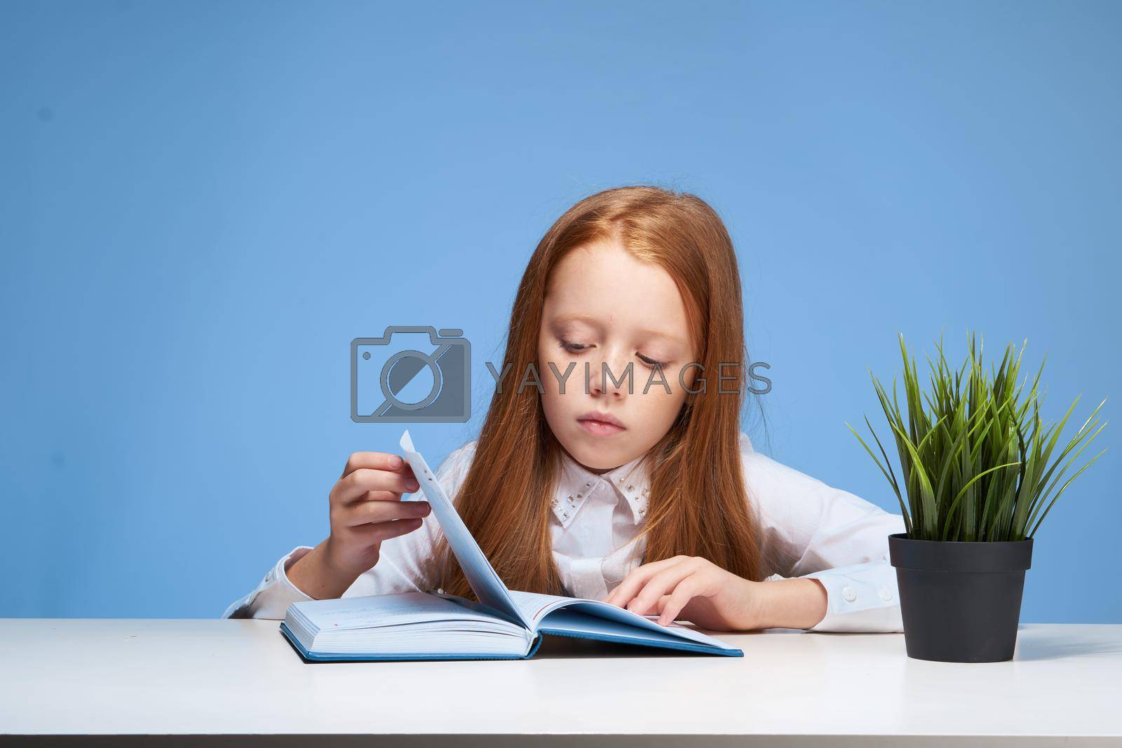 schoolgirl doing homework at the table education learning. High quality photo