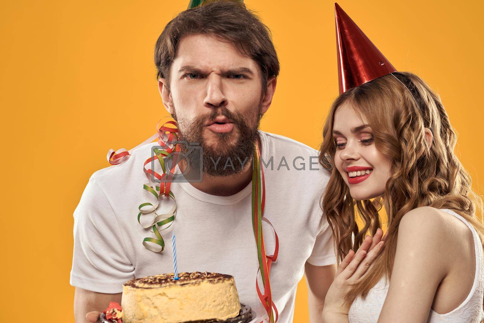 Man and woman celebration fun birthday cake. High quality photo