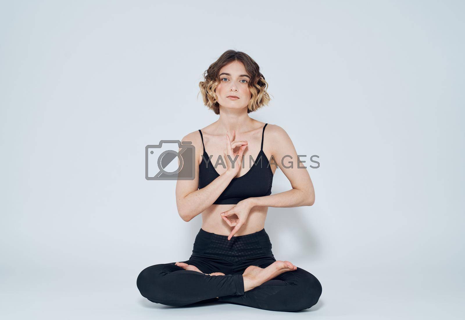 Royalty free image of Woman meditates on a light background yoga asana by SHOTPRIME