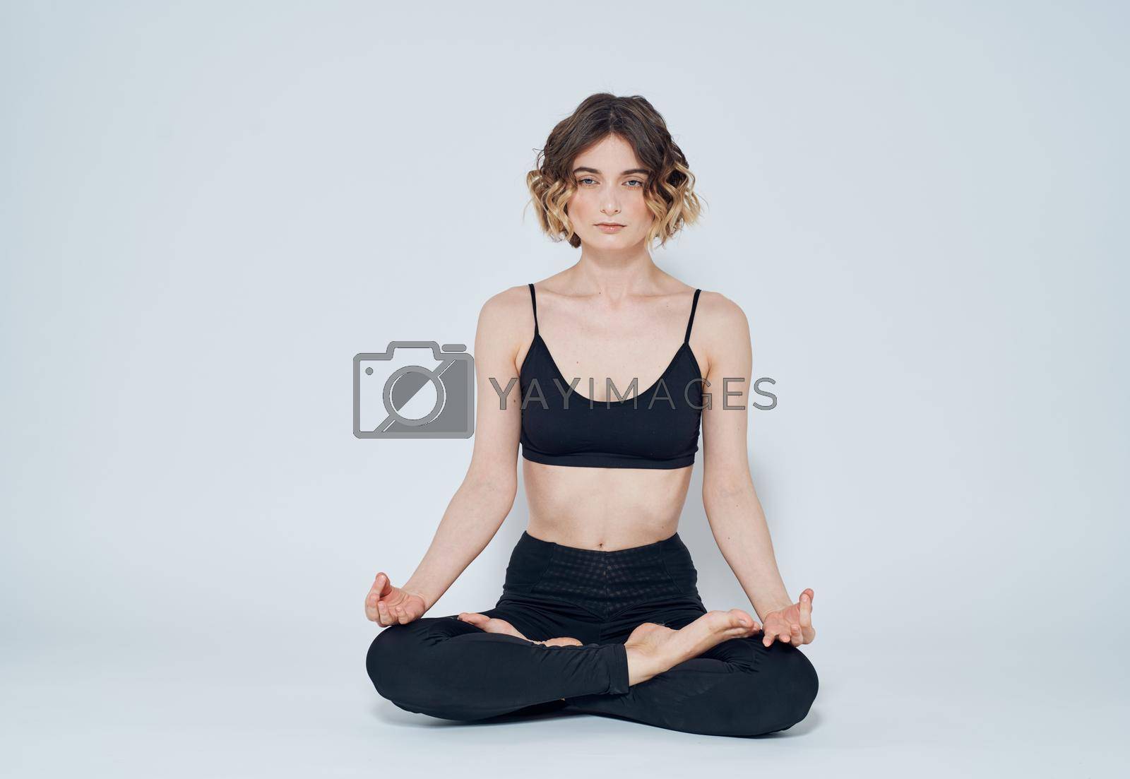 Woman meet legs sitting on the floor meditation yoga asana. High quality photo