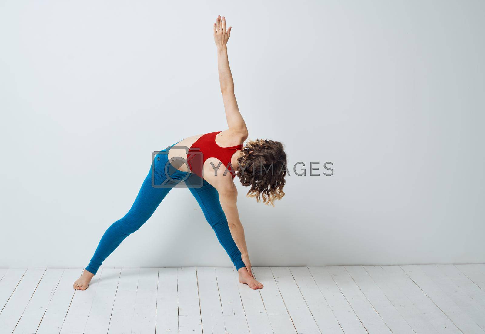 Woman spread her legs bent forward sport fitness gymnastics yoga. High quality photo