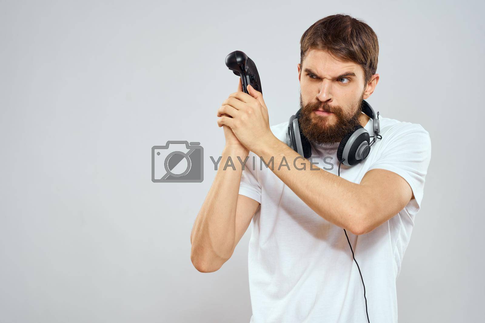Man with headphones Joystick in hands playing technology lifestyle. High quality photo