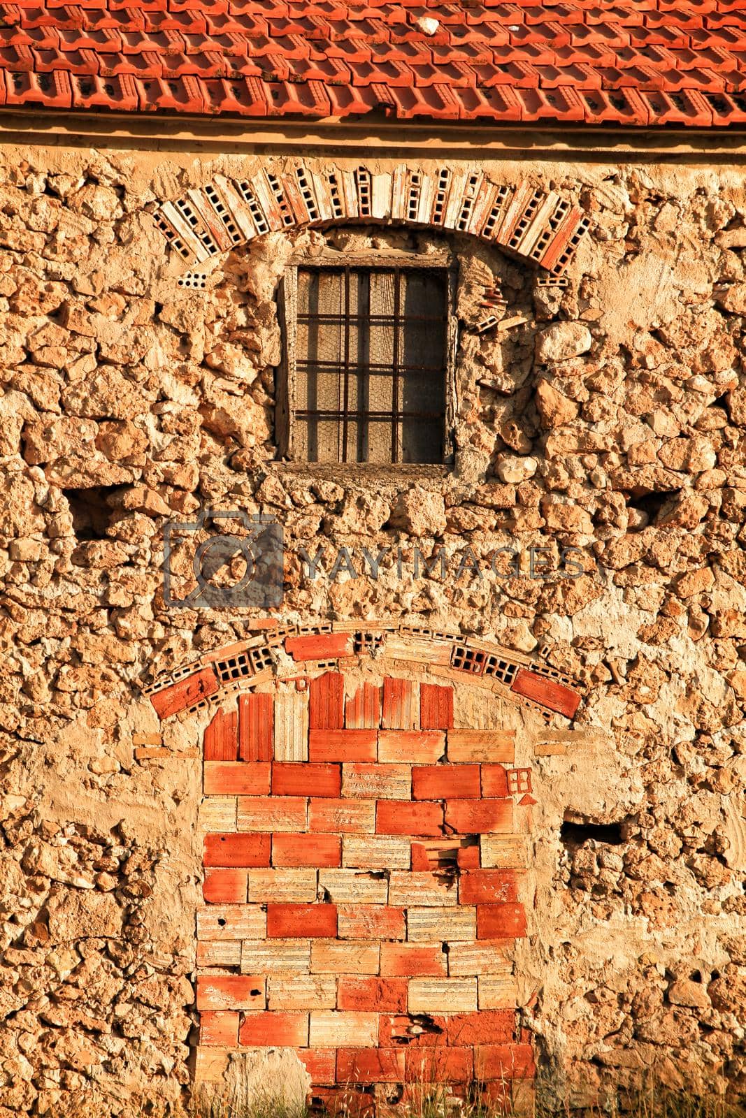 Royalty free image of Door and window boarded up with bricks by soniabonet