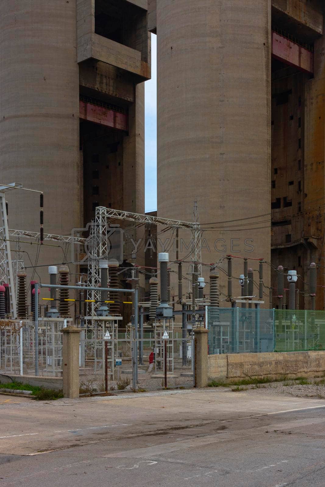 Old disused thermal power plant for the production of electricity in Barcelona behind a metal fence in Barcelona Spain
