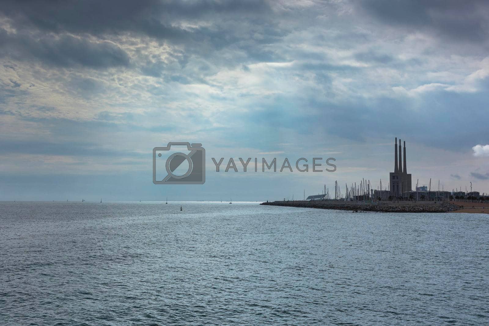 Seascape in the Mediterranean Sea with views of an old disused Thermal Power Plant for the production of electricity in Barcelona