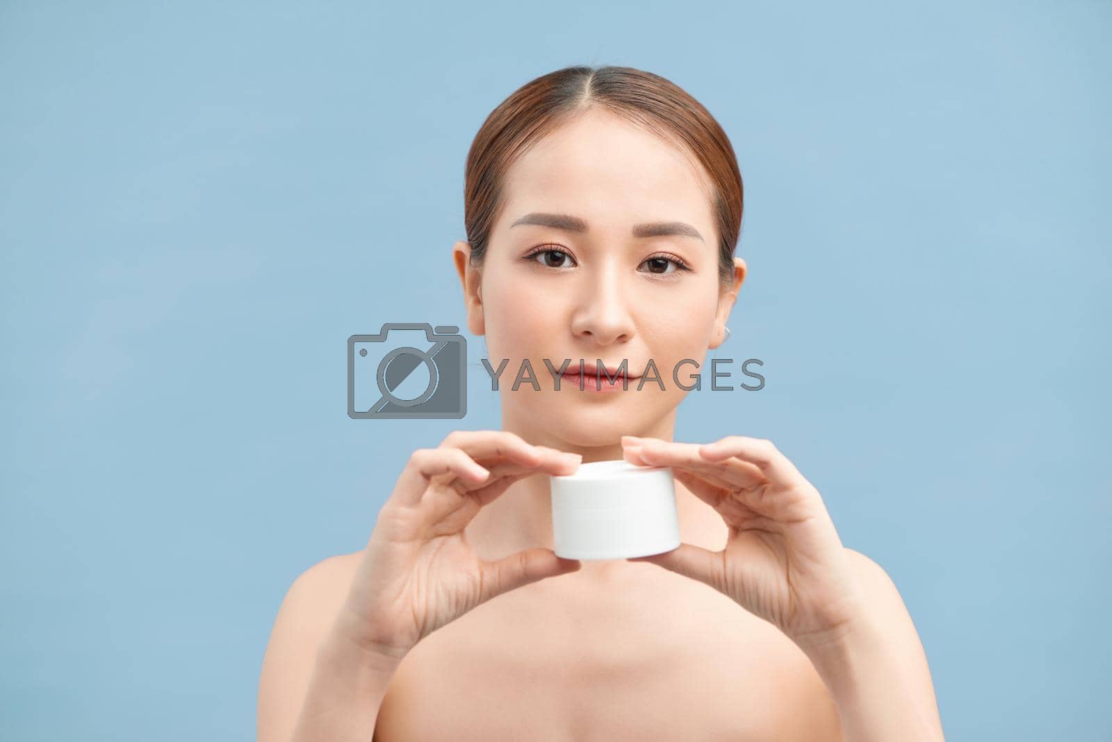 Royalty free image of beautiful woman applying cosmetic cream,solated with clipping path by makidotvn